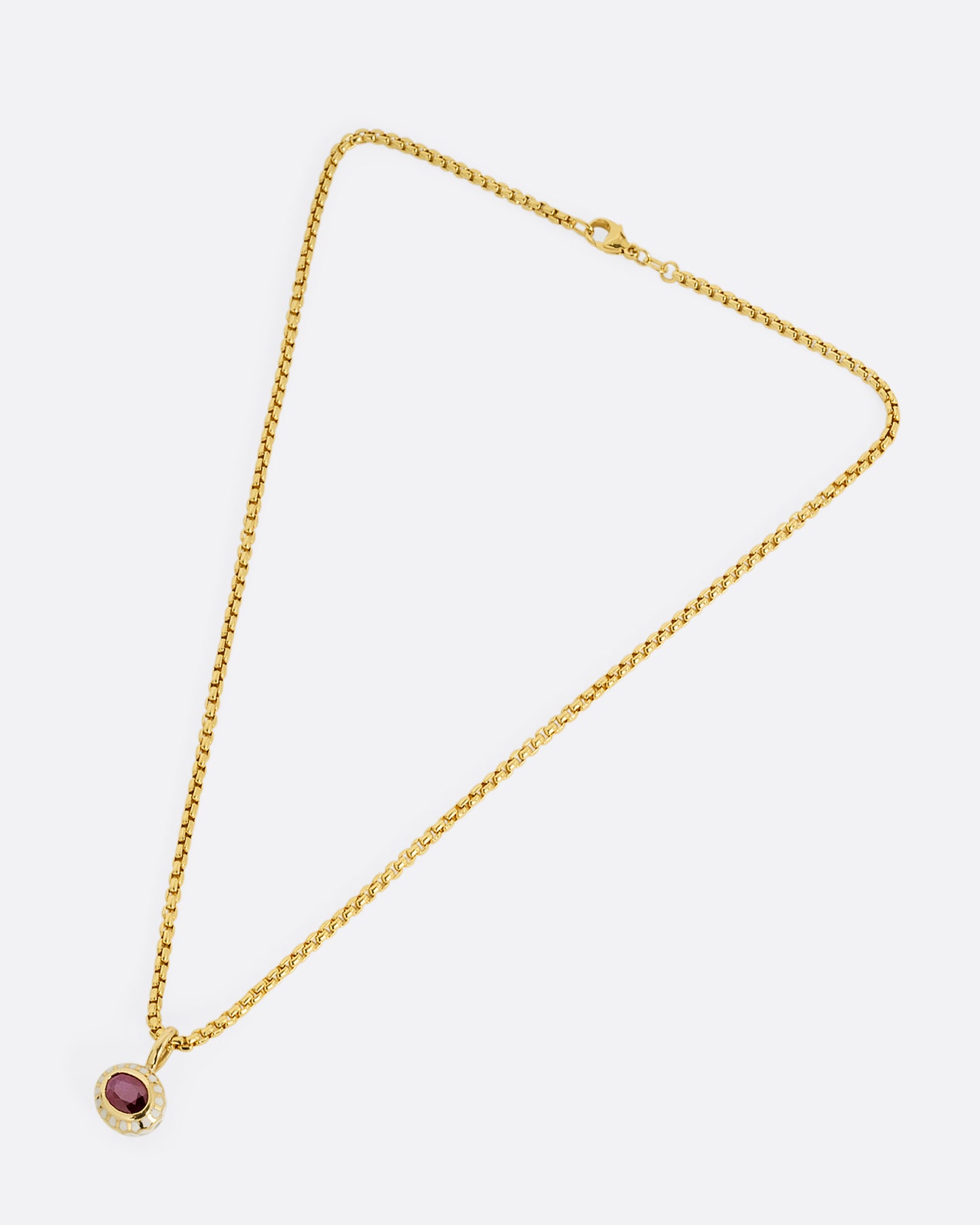 yellow gold ruby pendant with enamel shown diagonally