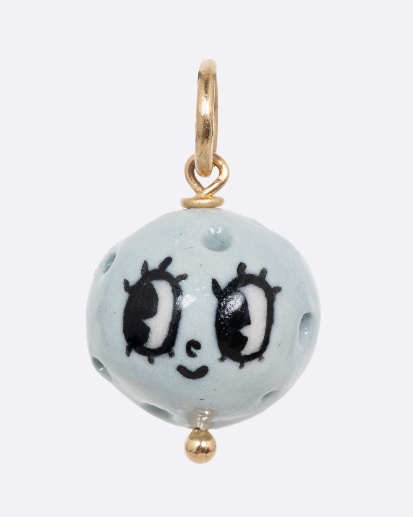 A blue full moon porcelain charm with a yellow gold bail. Shown from the front.