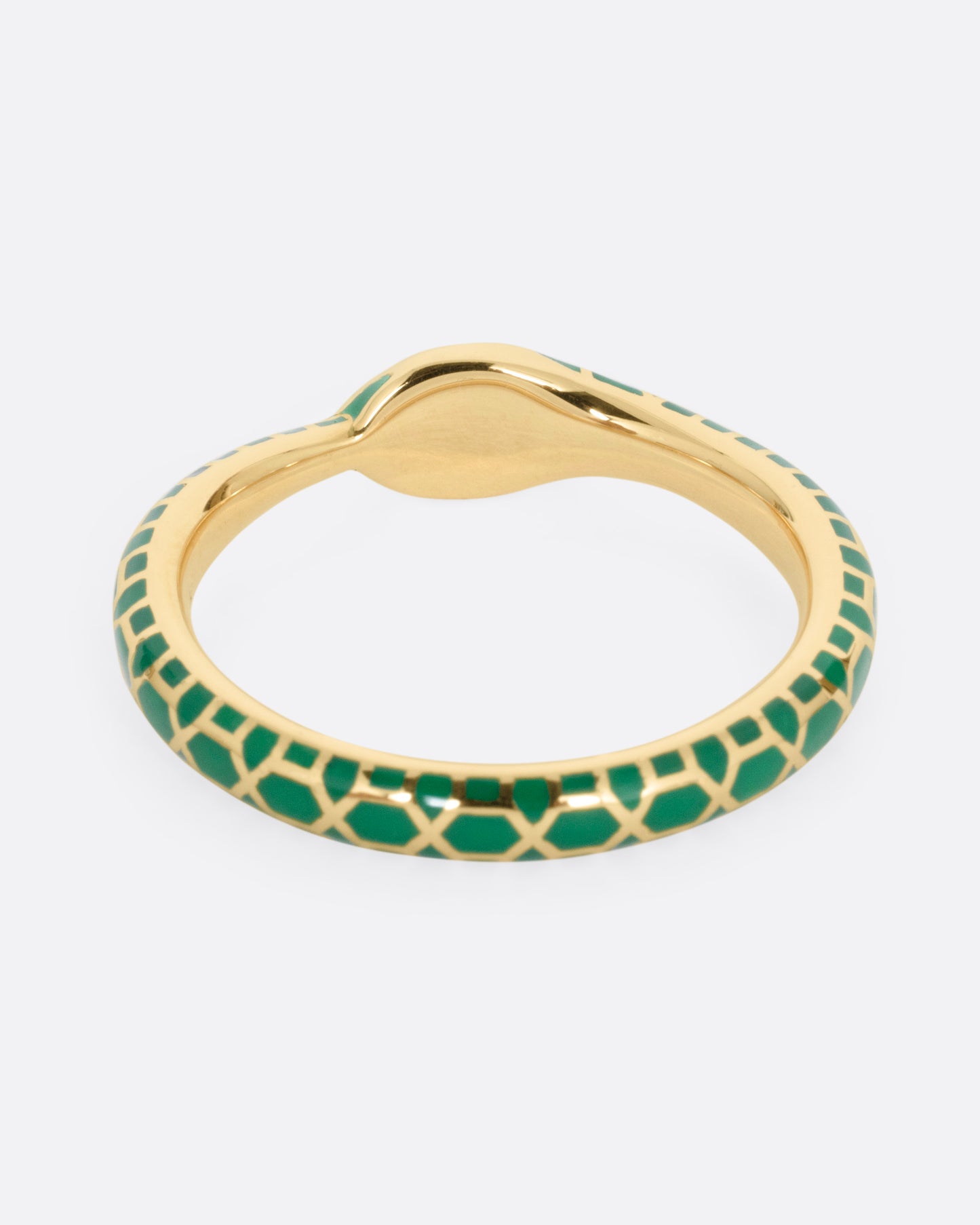 A yellow gold ouroboros ring with sapphire eyes and a green enamel snake skin pattern, shown from the back.