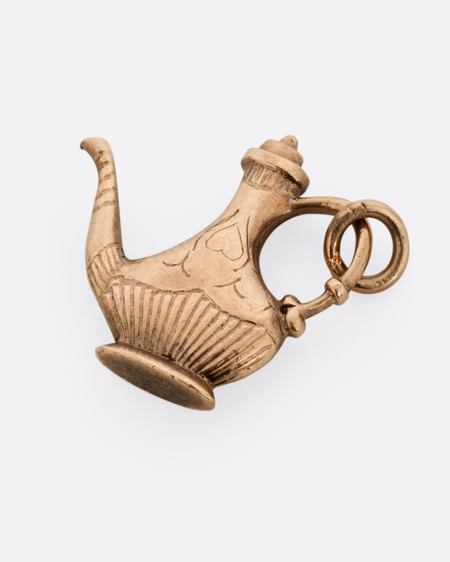 A yellow gold oil lamp charm. Shown lying flat from the front.