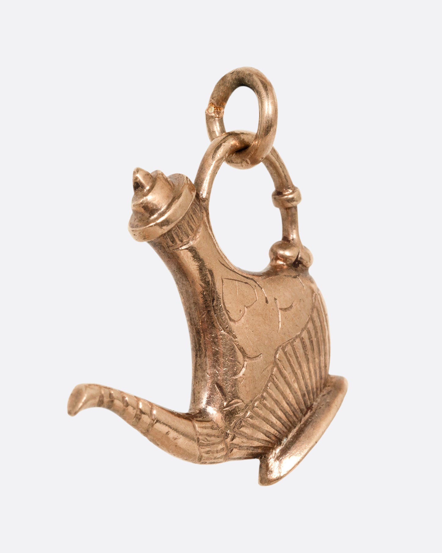 A yellow gold oil lamp charm. Shown from the side.