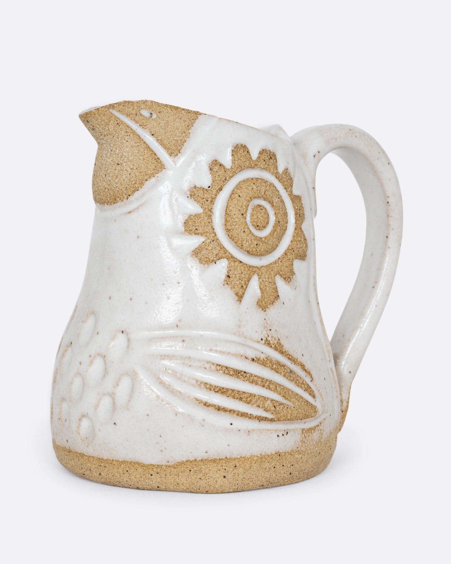 A white bird shaped creamer with a handle. Shown from the side.