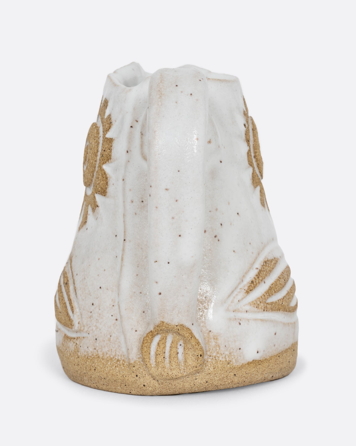 A white bird shaped creamer with a handle. Shown from the back.