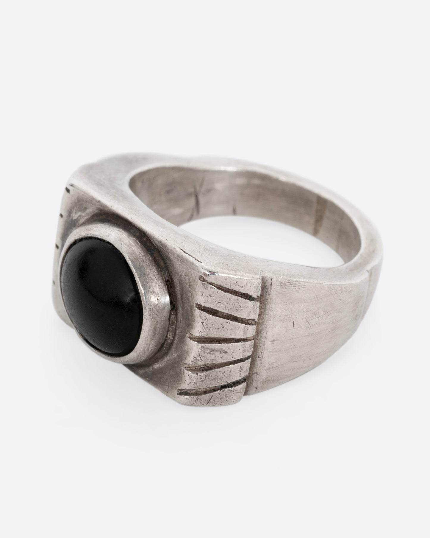 A silver ring with an oval onyx. Shown from the side.