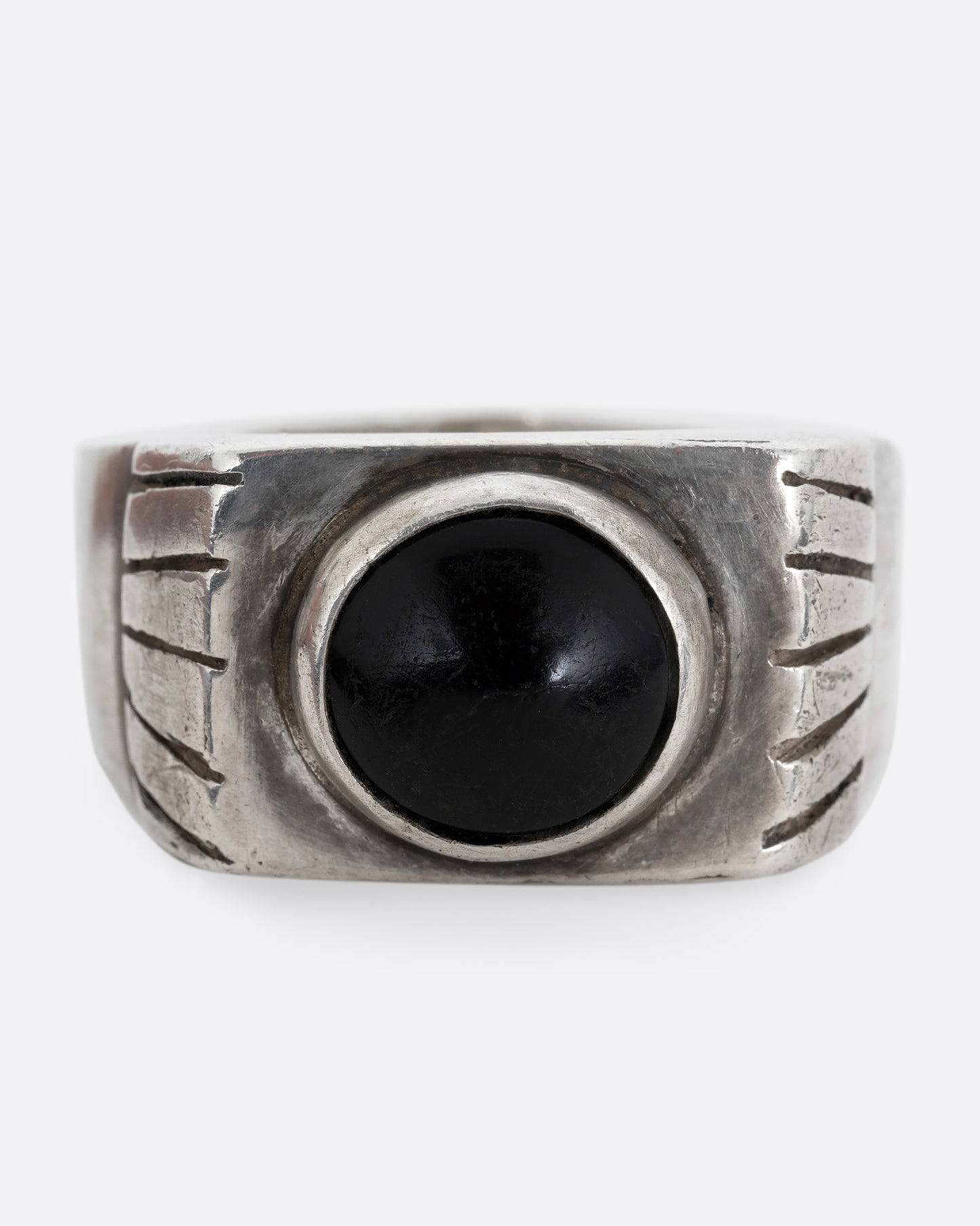 A silver ring with an oval onyx. Shown from the front.