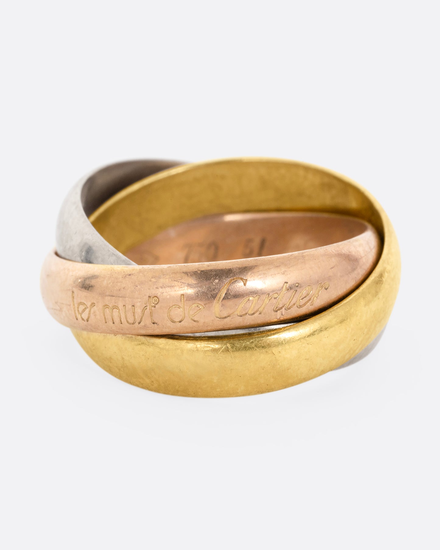 A ring with three interlocking bands in yellow, rose, and white gold, shown from the front.