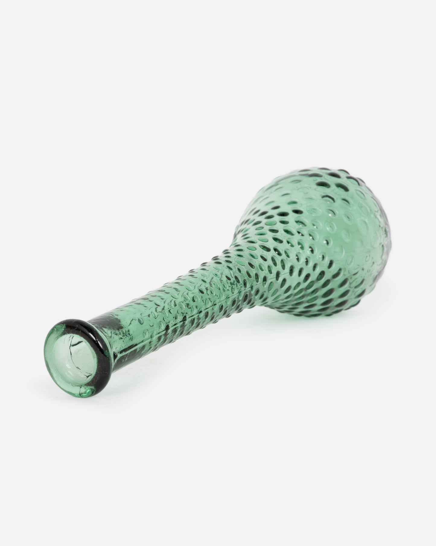 A green glass vase with a raised bubble texture. Shown diagonally on its side from the top.