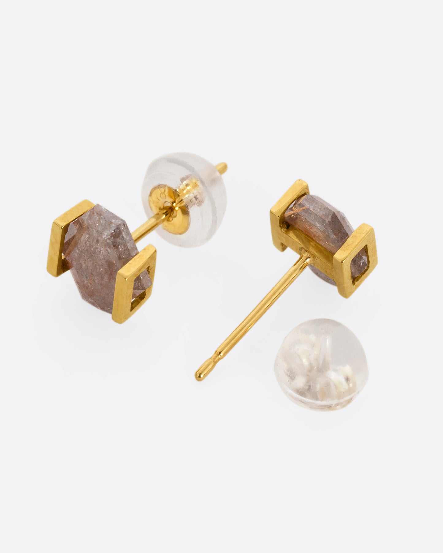 Yellow gold earrings with rustic diamonds in open rectangular settings. One earring is shown lying flat from the front. The other earring is shown lying flat open from the back.