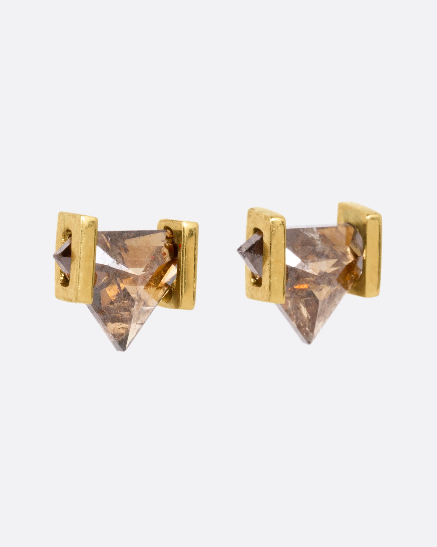 Yellow gold earrings with open rectangular settings and cognac diamonds. Shown from the side.