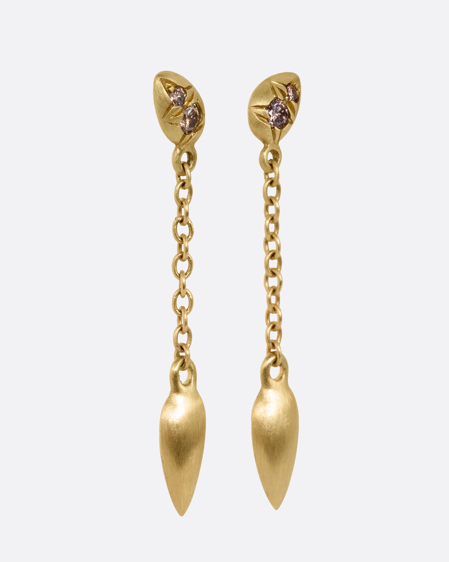 Yellow gold earrings with brown diamonds and cable chain drops. Shown from the side.