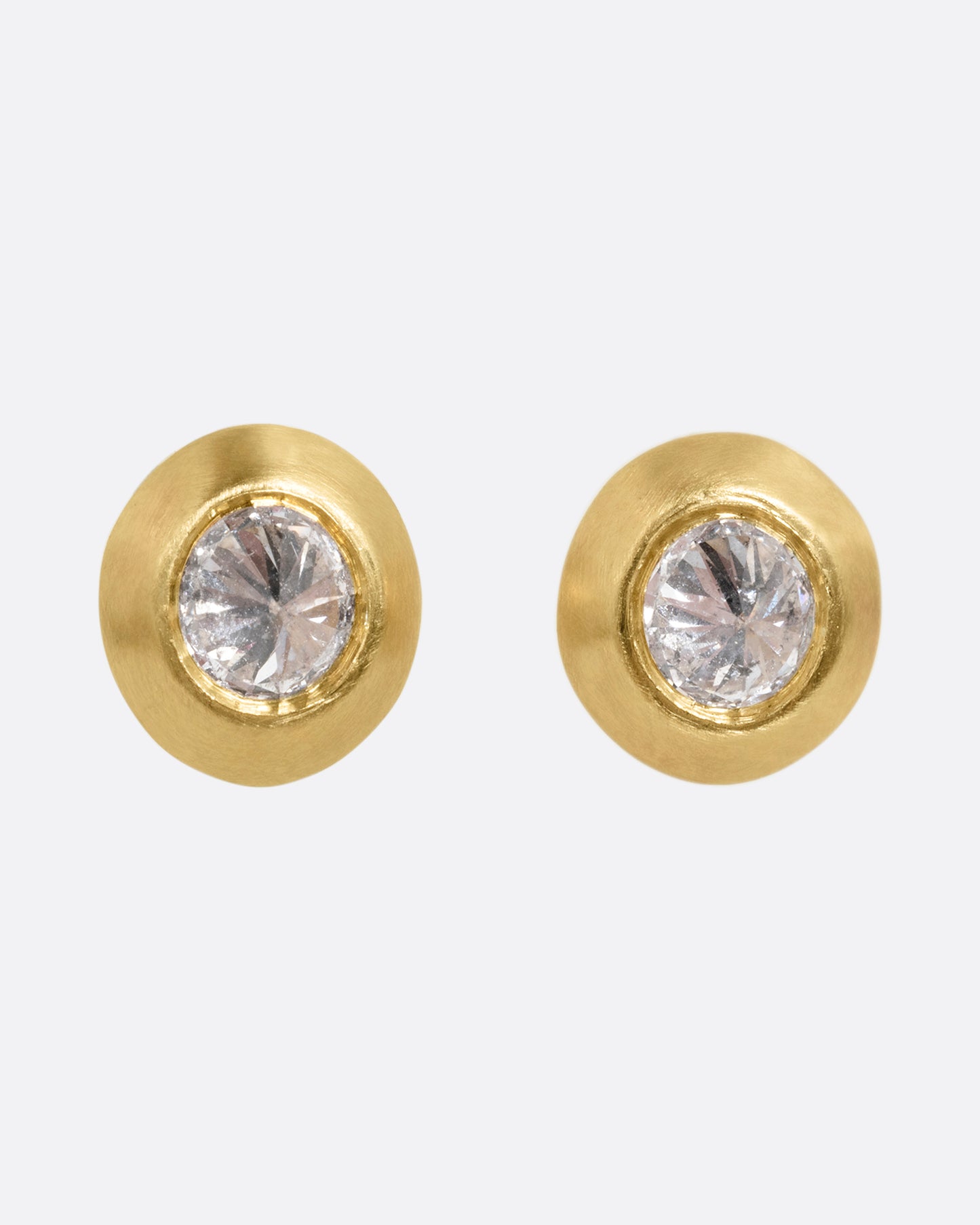 Reverse set diamond stud earrings in yellow gold. Shown from the front.