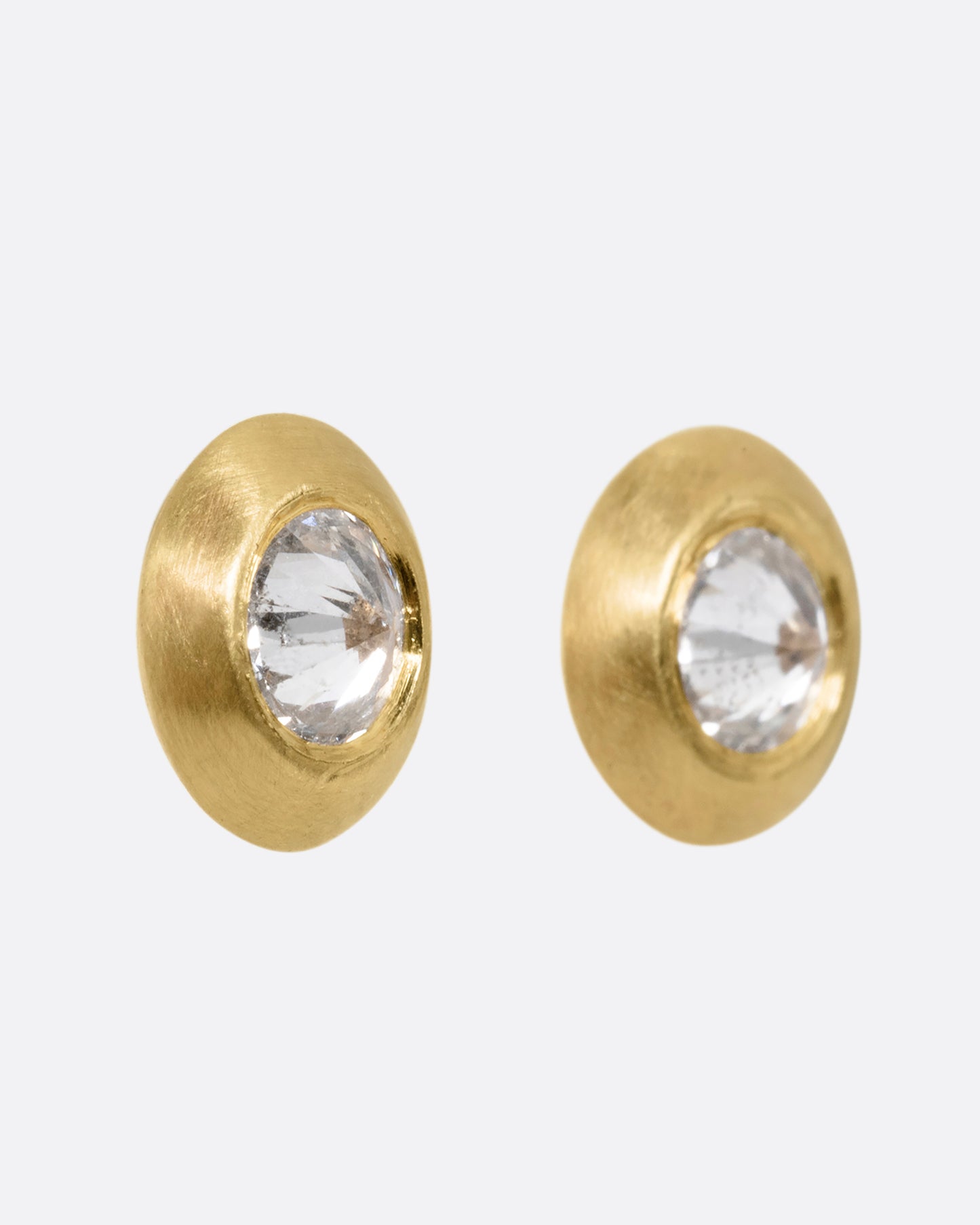Reverse set diamond stud earrings in yellow gold. Shown from the side.