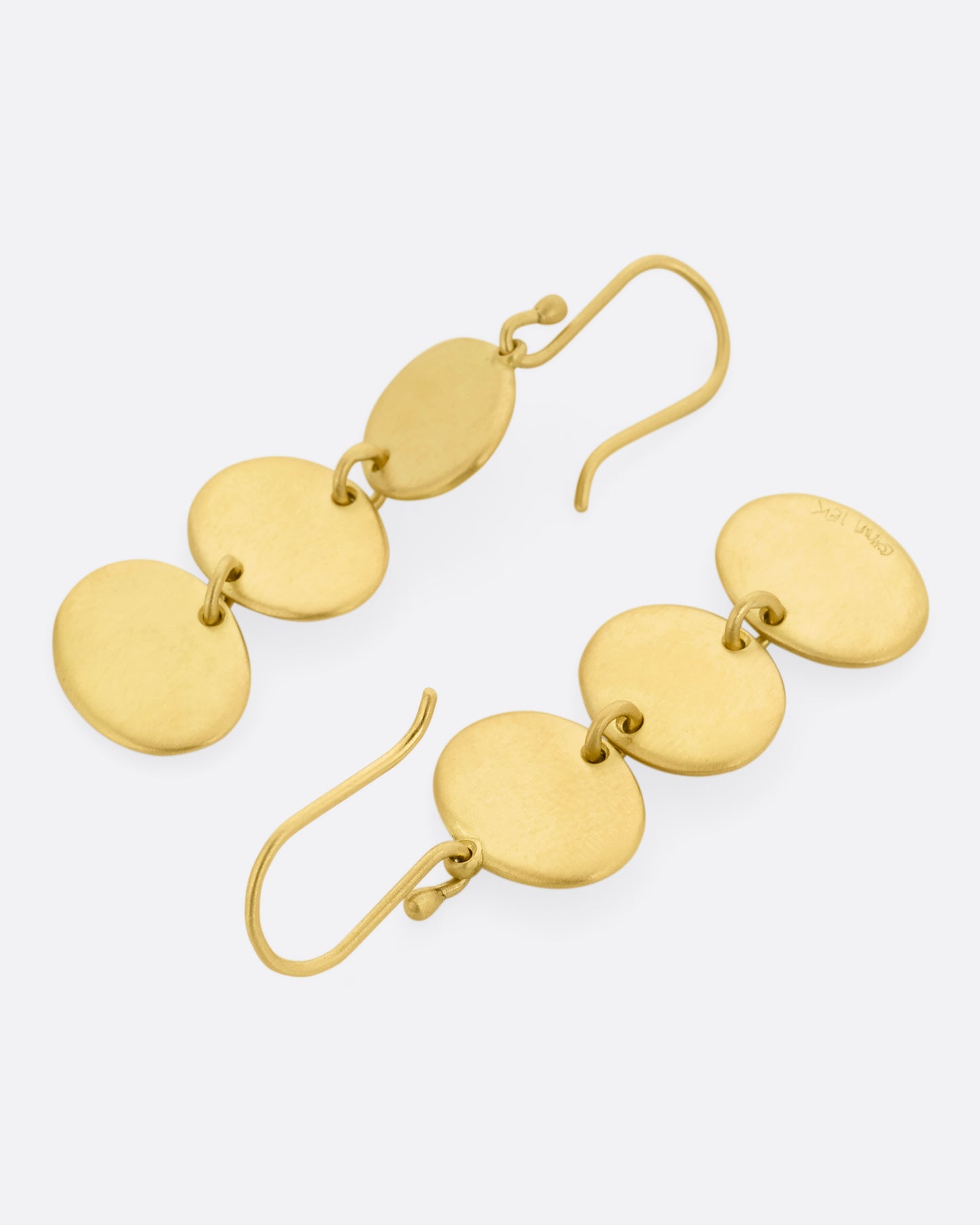 A pair of yellow gold dangle earrings with three linked ovals. One earring is shown lying flat from the front, the other from the back.