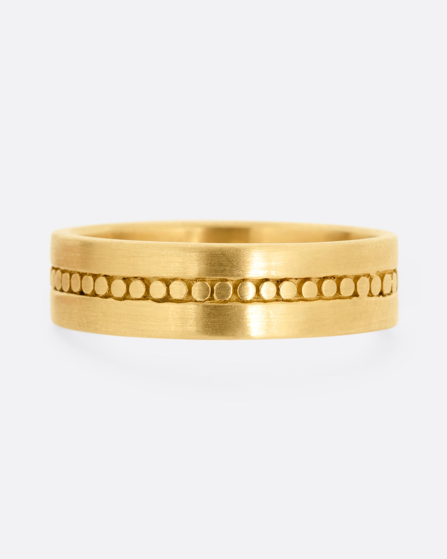 A yellow gold band with a center stripe of circles. Shown from the front.