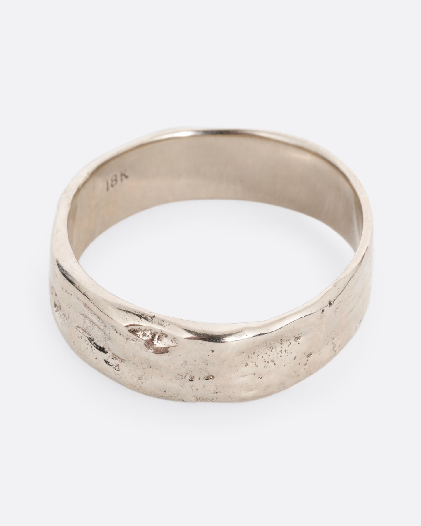 A white gold band with a textured and polished finish. Shown from the front.