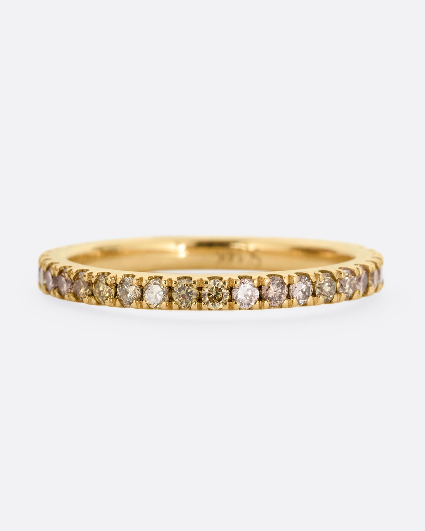 A yellow gold eternity band with olive, champagne, and cognac diamonds. Shown from the front.