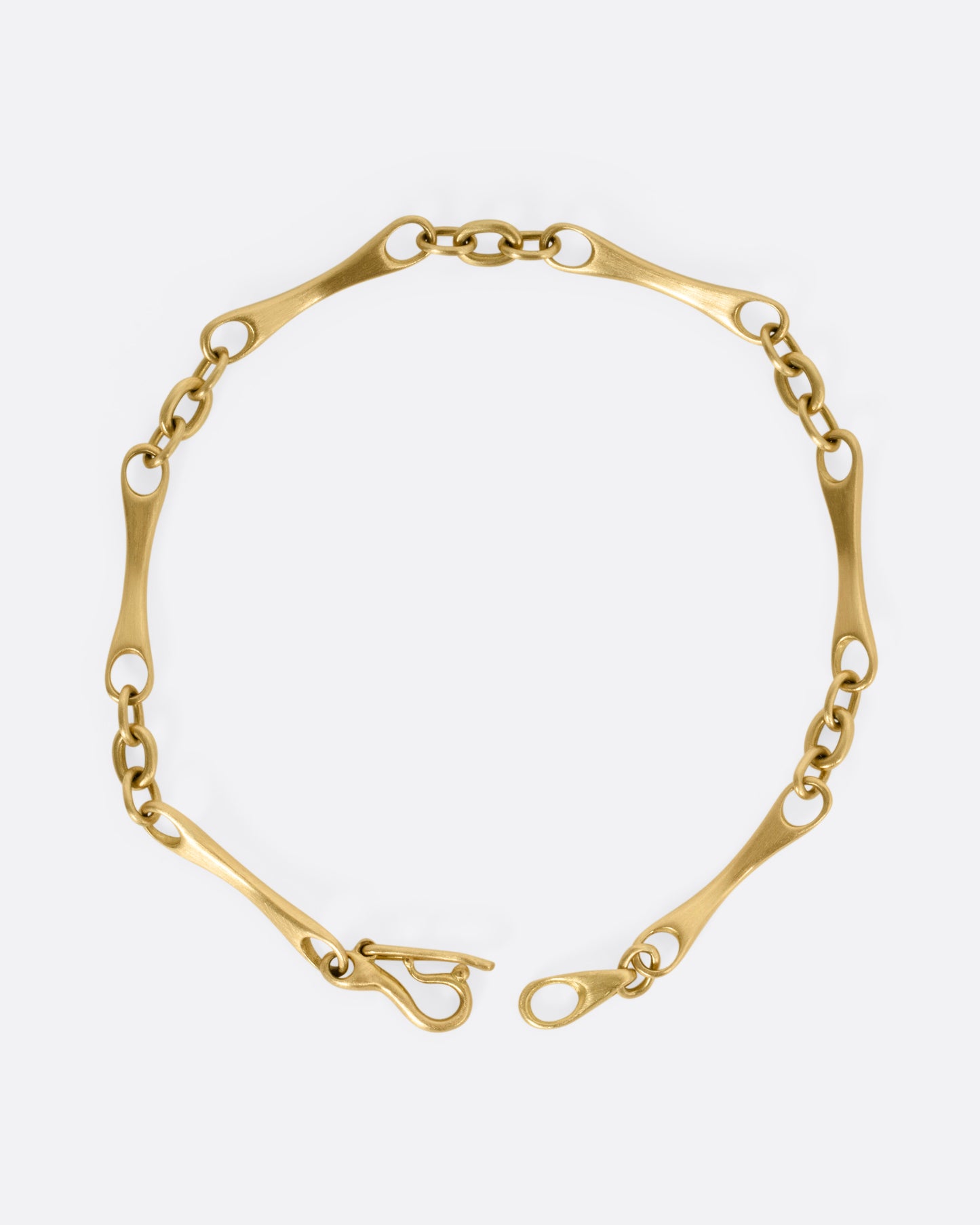 A yellow gold link bracelet, shown from the top open.