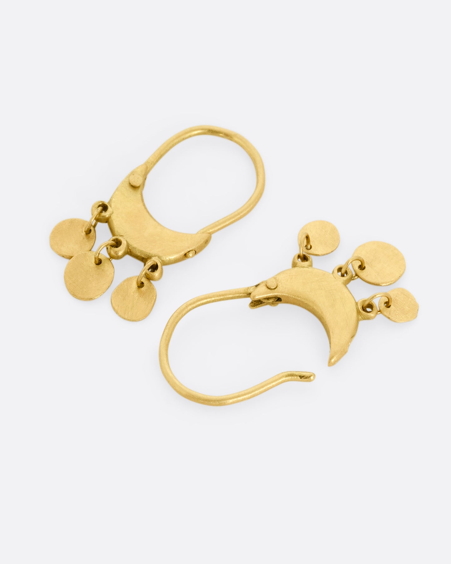 A pair of yellow gold chandelier hoop earrings. One earring is shown lying flat from the bottom, the other is shown lying flat open from the top.
