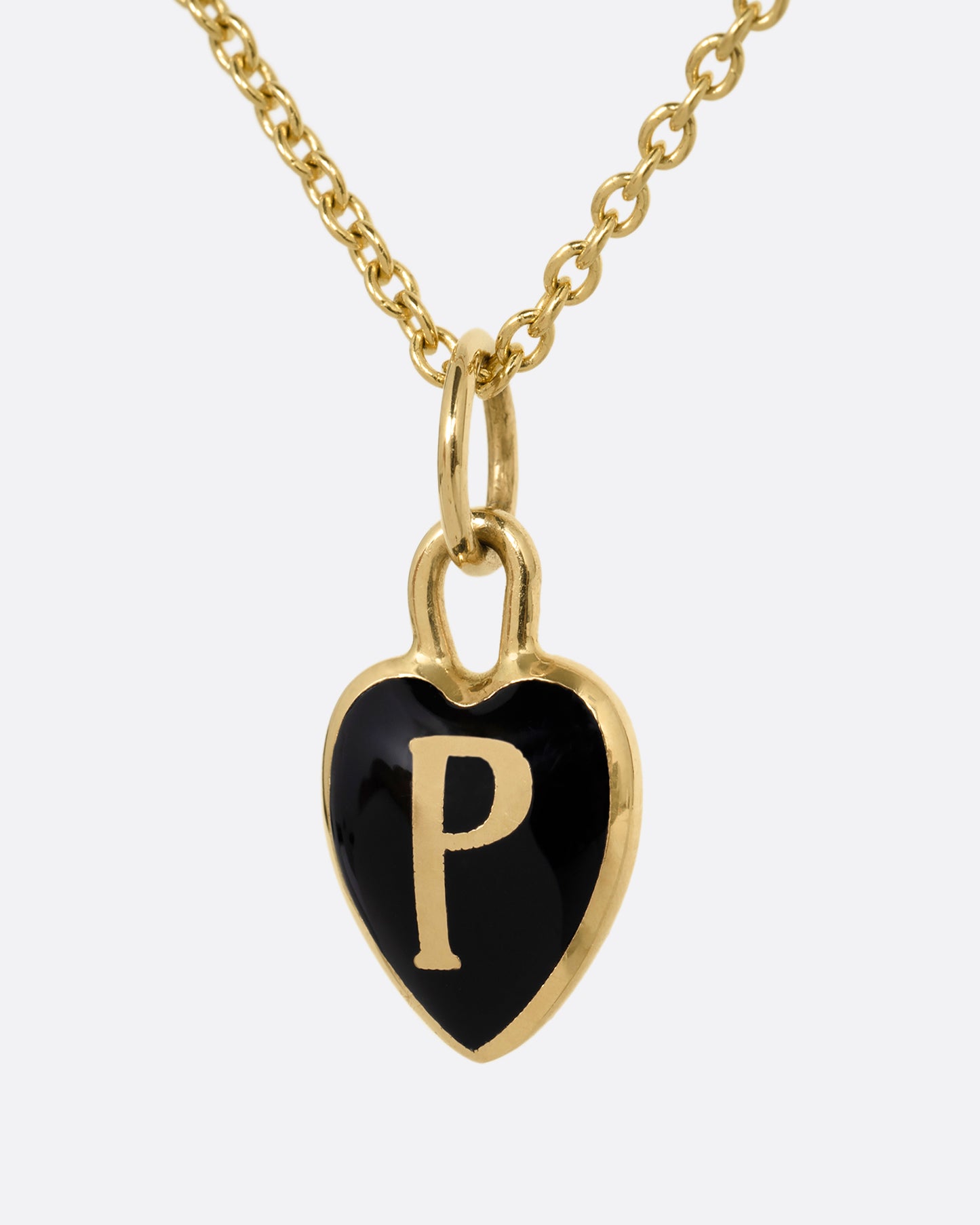 A yellow gold cable chain necklace with a black enamel 'P' heart pendant. Shown from the front.