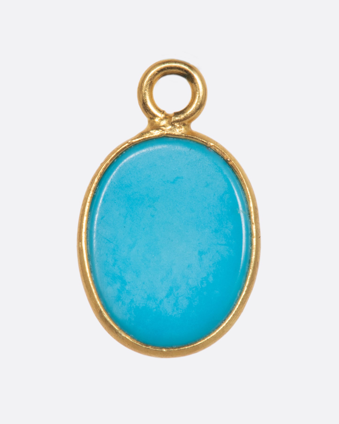 A Sleeping Beauty Turquoise dangle set in yellow gold with a yellow gold bail. Shown from the back.