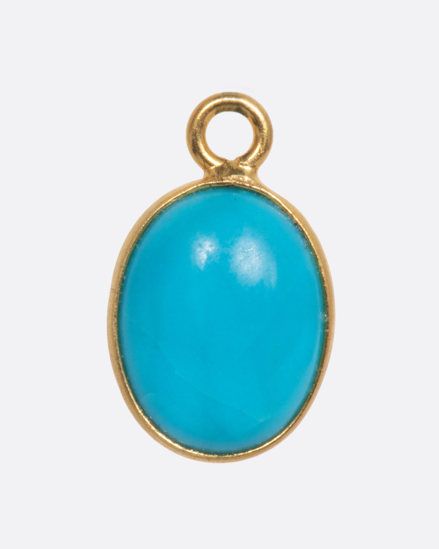 A Sleeping Beauty Turquoise dangle set in yellow gold with a yellow gold bail. Shown from the front.