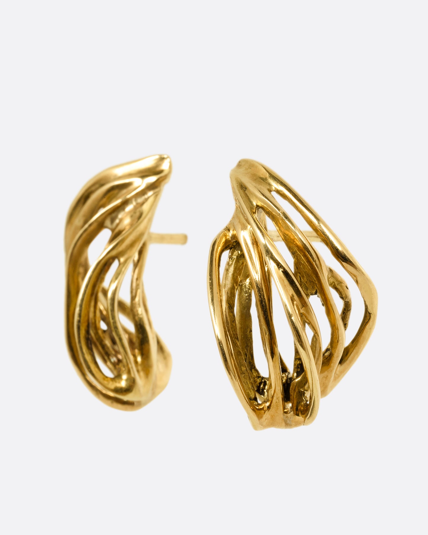 A pair of yellow gold stud earrings with clusters of intertwined gold strands. Shown from the side.