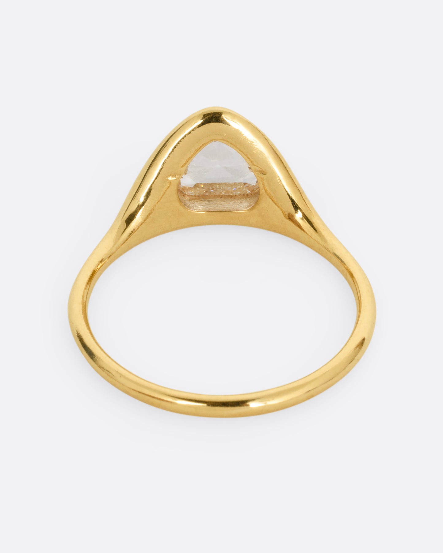 A yellow gold ring with a triangular rose cut diamond. Shown from the back.