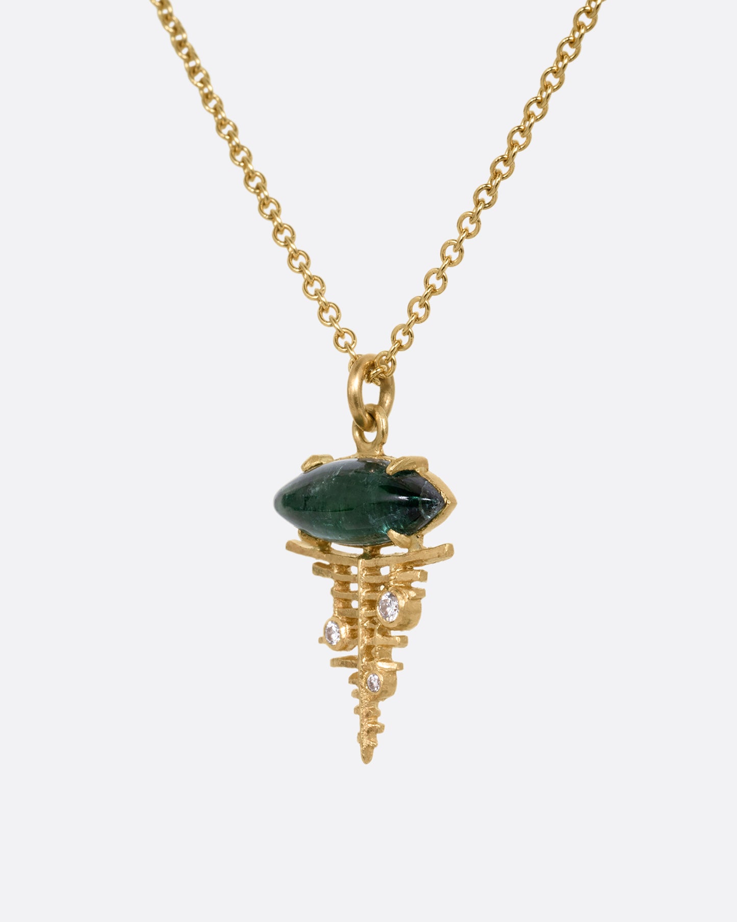 A yellow gold cable chain necklace with a deep green tourmaline cabochon at the top of a diamond studded gold lattice. Shown from the side.