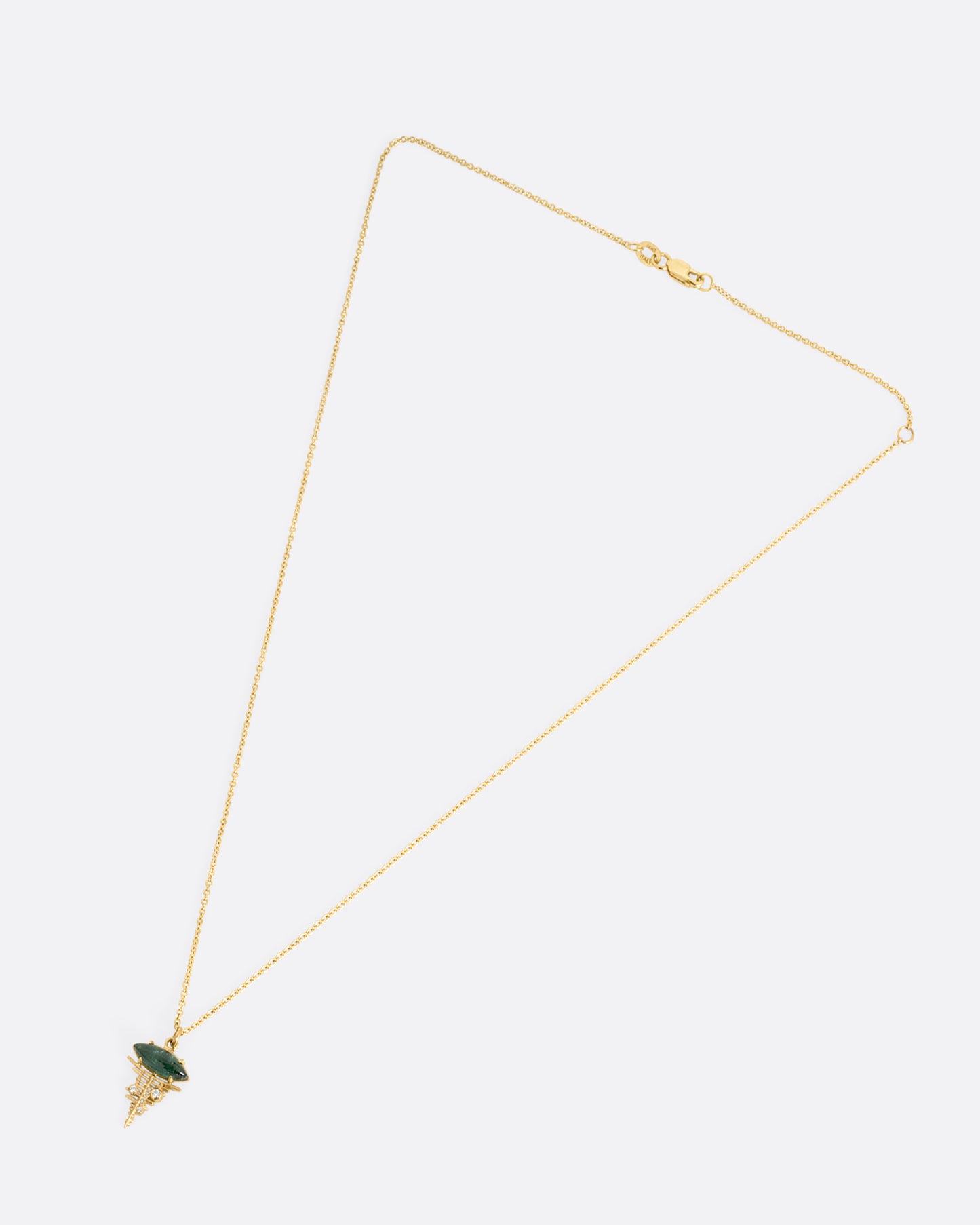 A yellow gold cable chain necklace with a deep green tourmaline cabochon at the top of a diamond studded gold lattice. Shown from the front.