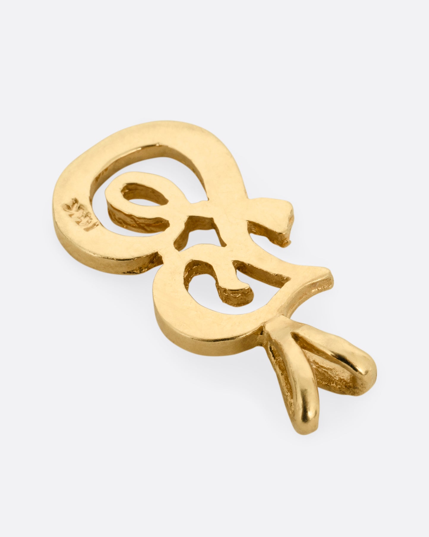 A yellow gold cursive 'F' charm with a double bill. Shown from the back.