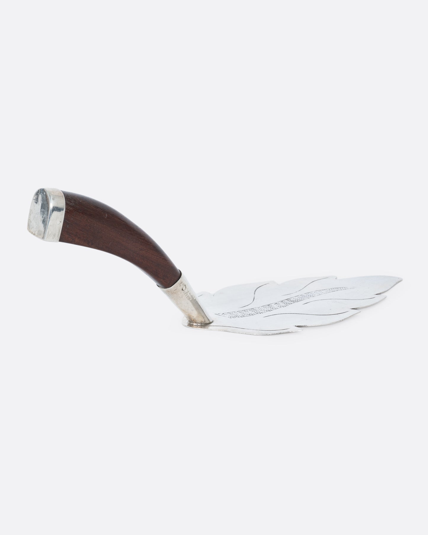 A silver leaf cake server with a wooden handle, shown from the side.