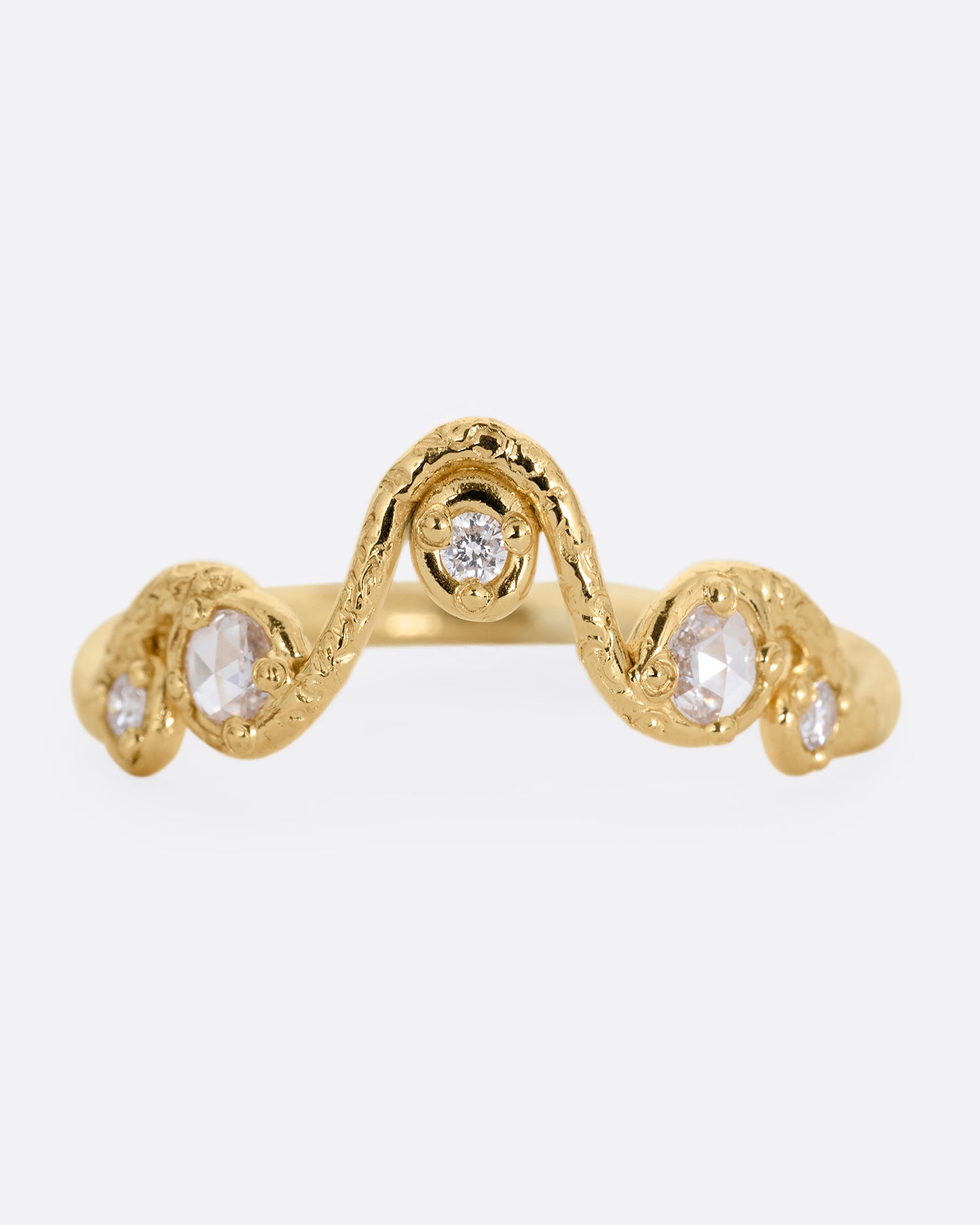 A wavy yellow gold ring with five round diamonds. Shown from the front.