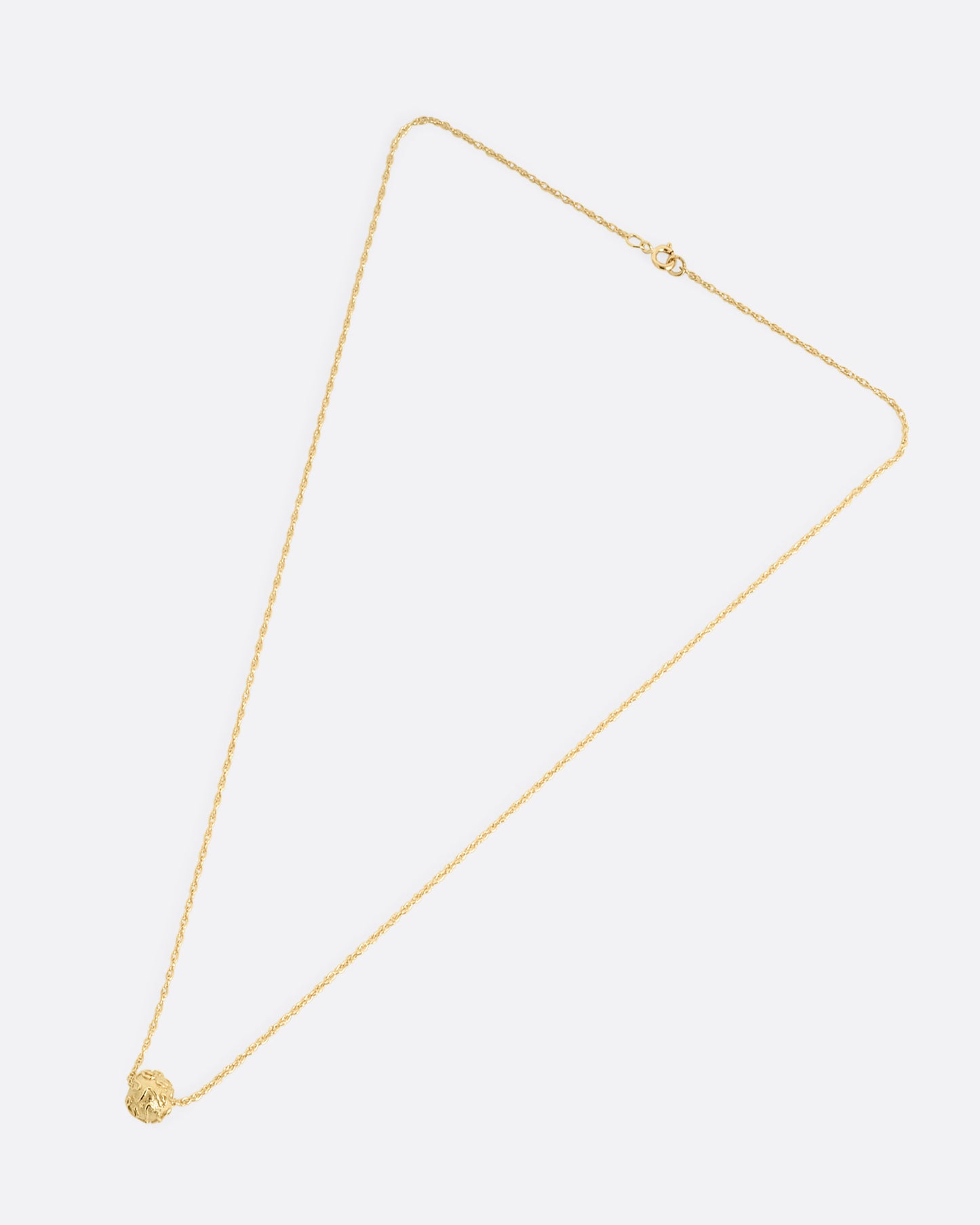 A yellow gold cable chain with a textured gold bead, shown from the front.