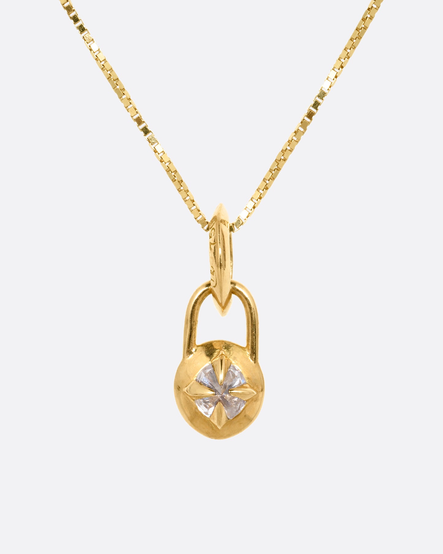 A yellow gold box chain with a padlock shaped pendant. A reverse set diamond is prong set in the center of the pendant. Shown from the front.