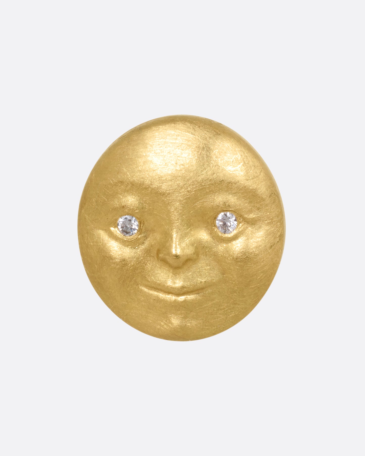 A yellow gold moon face stud earring with diamond eyes. Shown from the front.