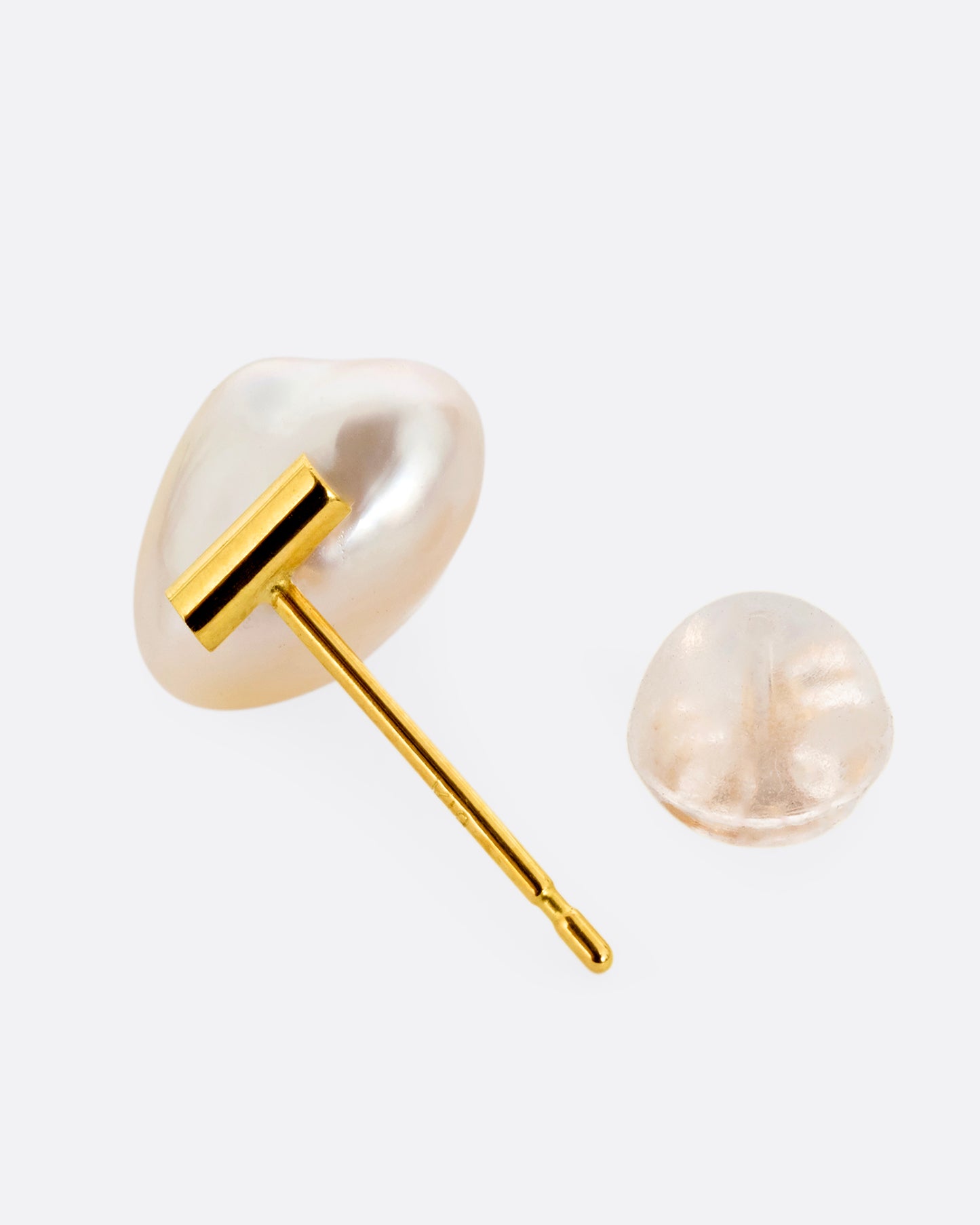 A pearl earring suspended from a gold bar setting. Shown from the top open.