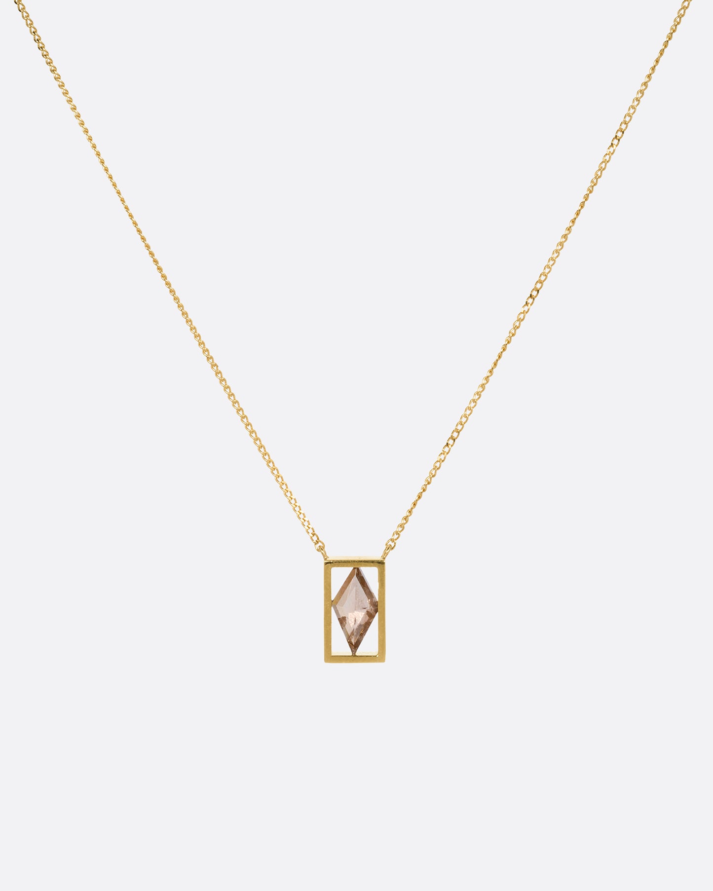 A yellow gold cable chain necklace with a rhombus shaped diamond in an open rectangular setting, shown from the front.