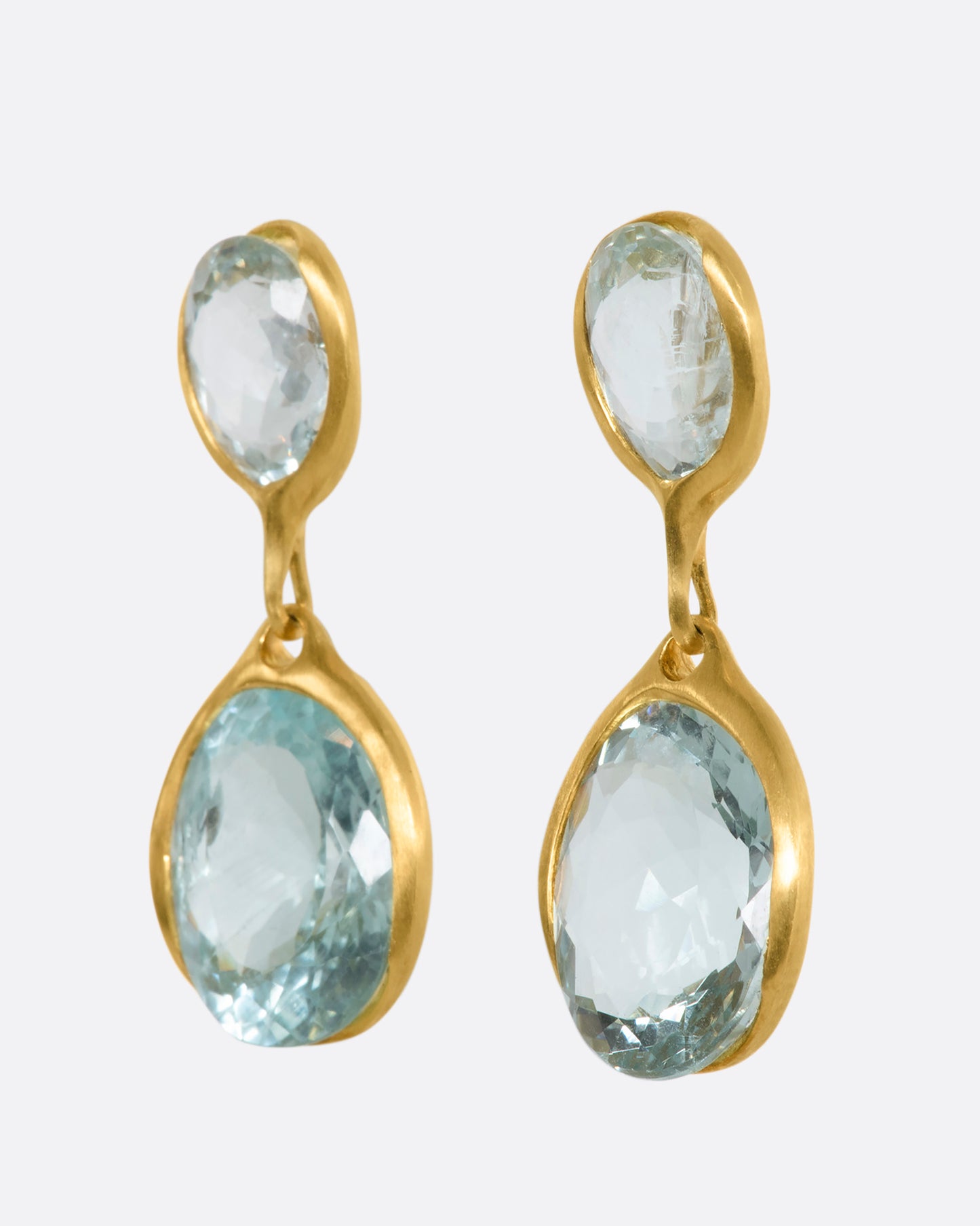 A pair of yellow gold aquamarine stud double drops. View from the side.
