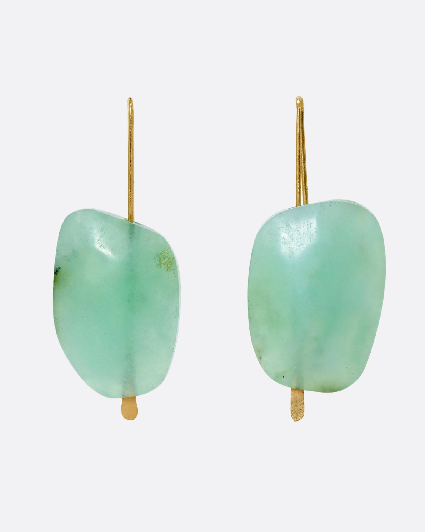 A pair of yellow gold hook earrings with a single freeform chrysoprase on each.
Shown from the front.