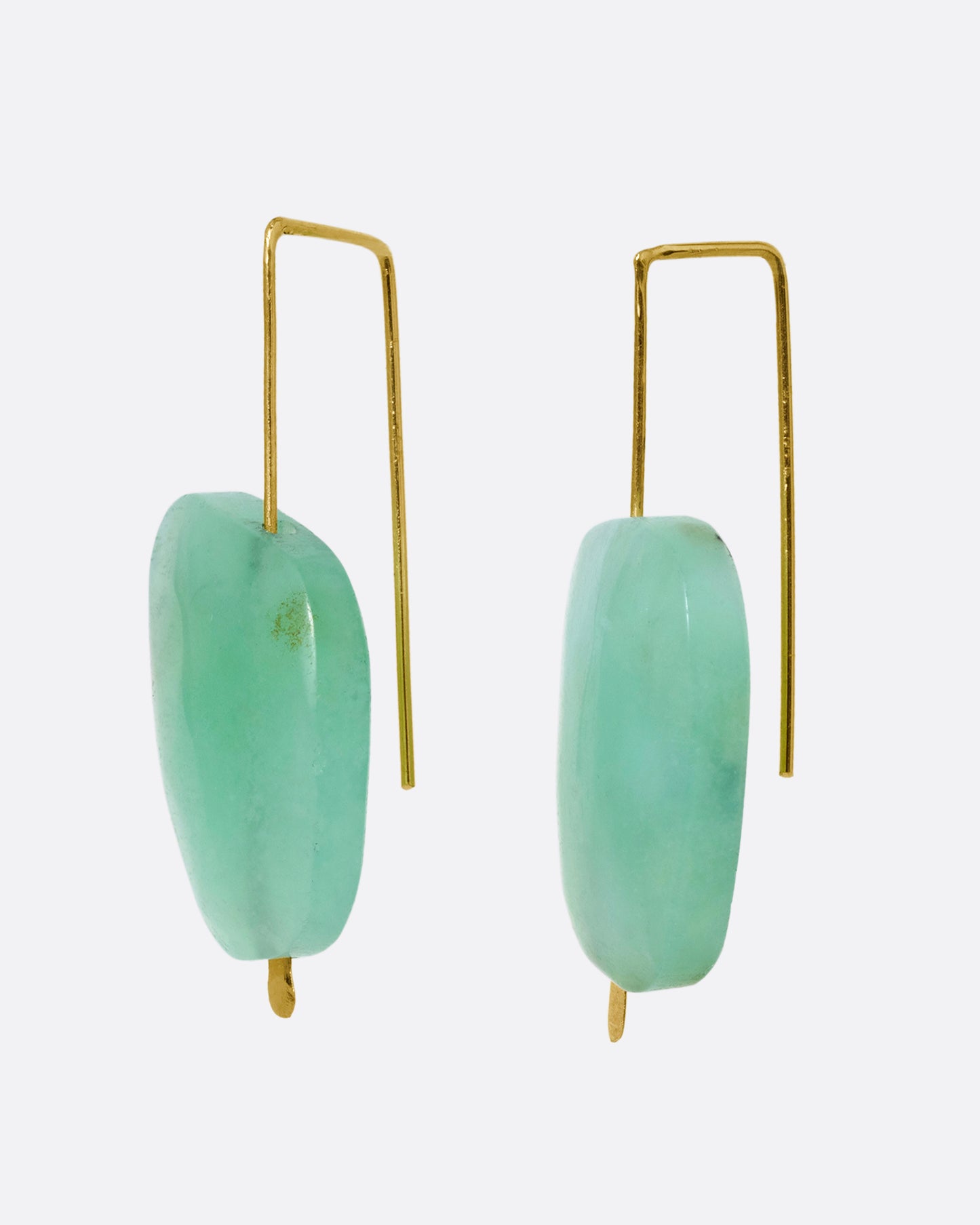A pair of yellow gold hook earrings with a single freeform chrysoprase on each.
Shown from the side.
