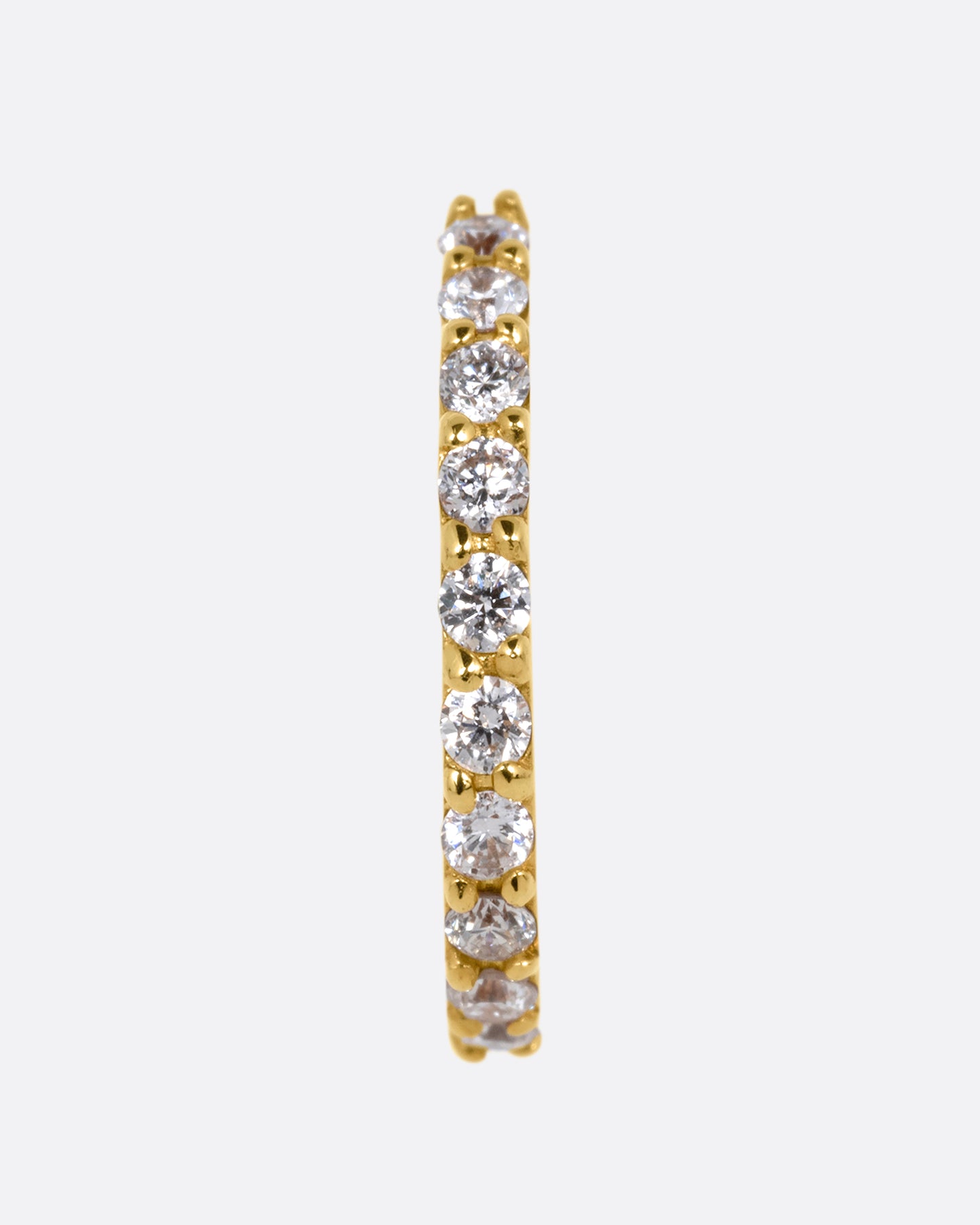 A half moon yellow gold stud with a diamond studded edge, shown from the front.
