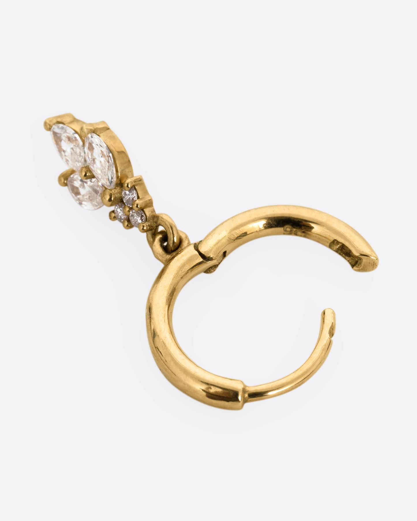 A yellow gold hoop with a marquise diamond flower dangle at the base, shown open from the side.