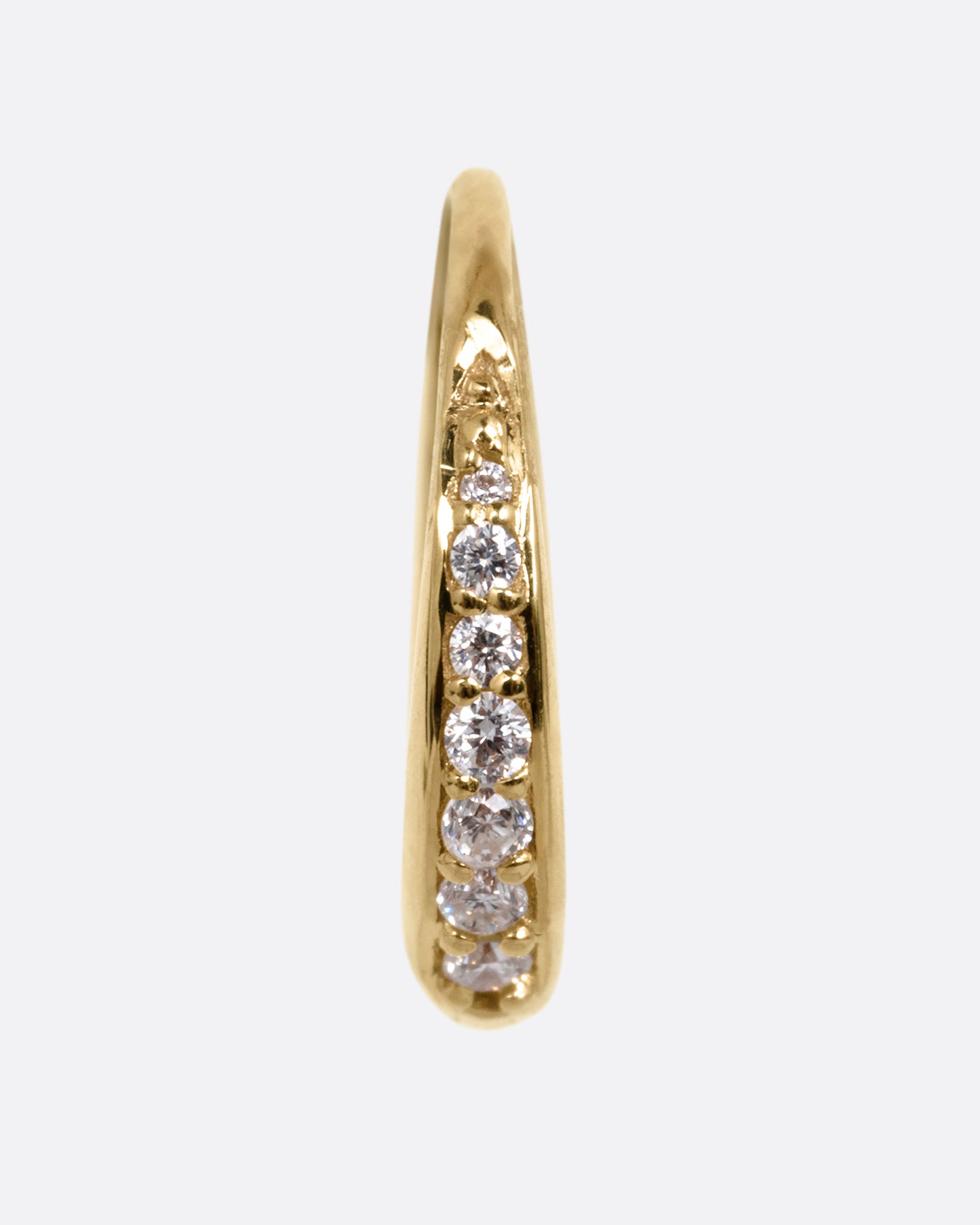 A yellow gold tapered hoop earring with a queue of graduated diamonds, shown from the front.