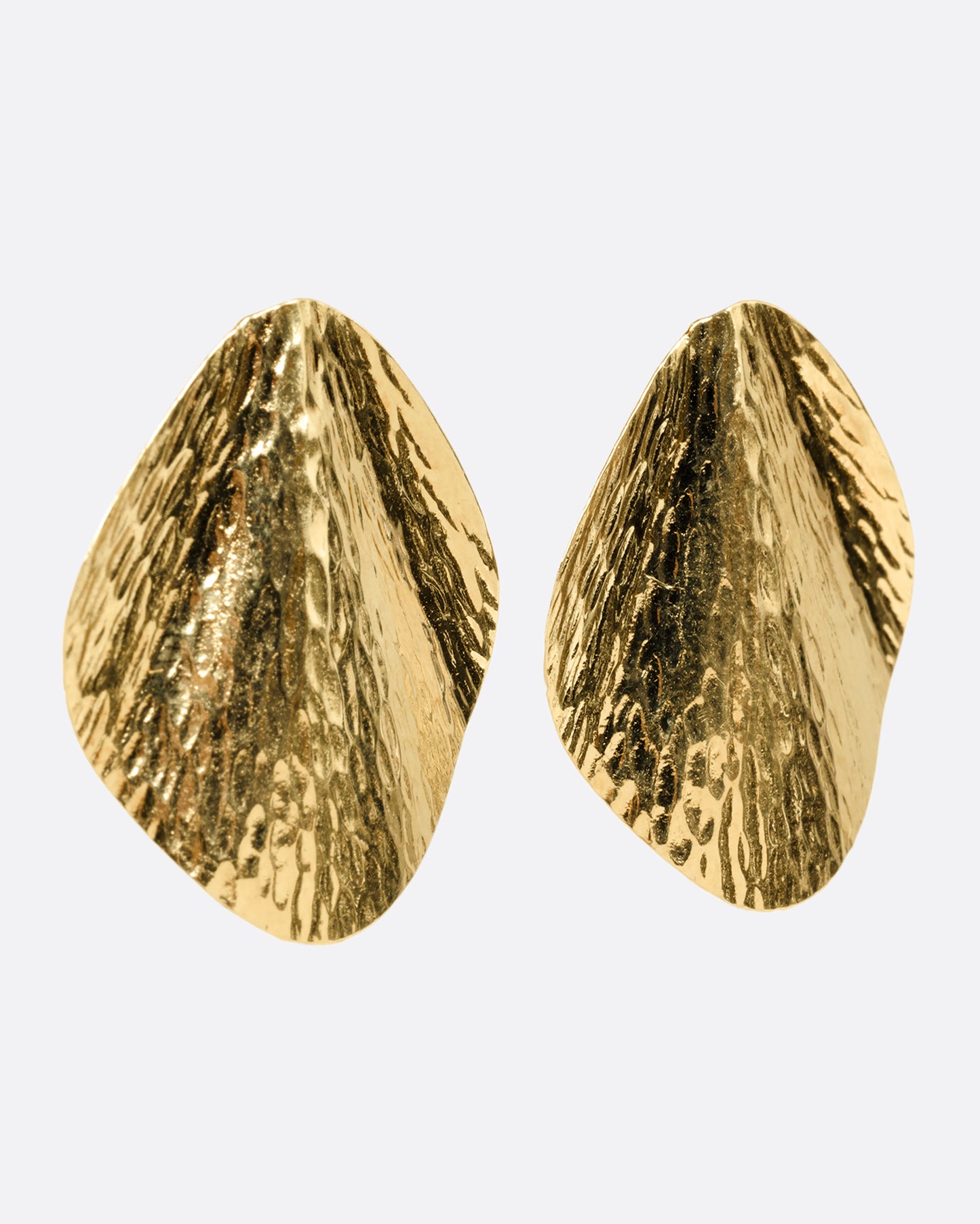 A pair of yellow gold stud earrings with a textural finish and wavy silhouette, shown from the side.
