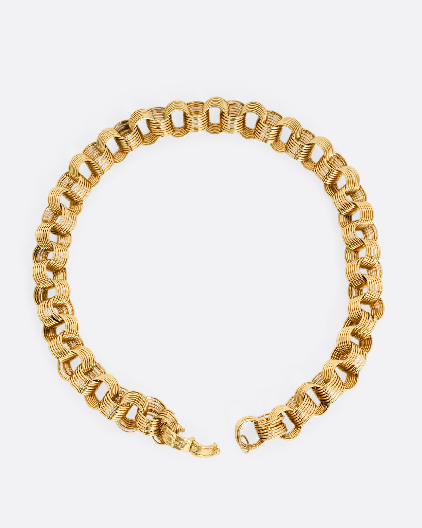 A yellow gold necklace with slanted stacked hoop links, shown from the front.