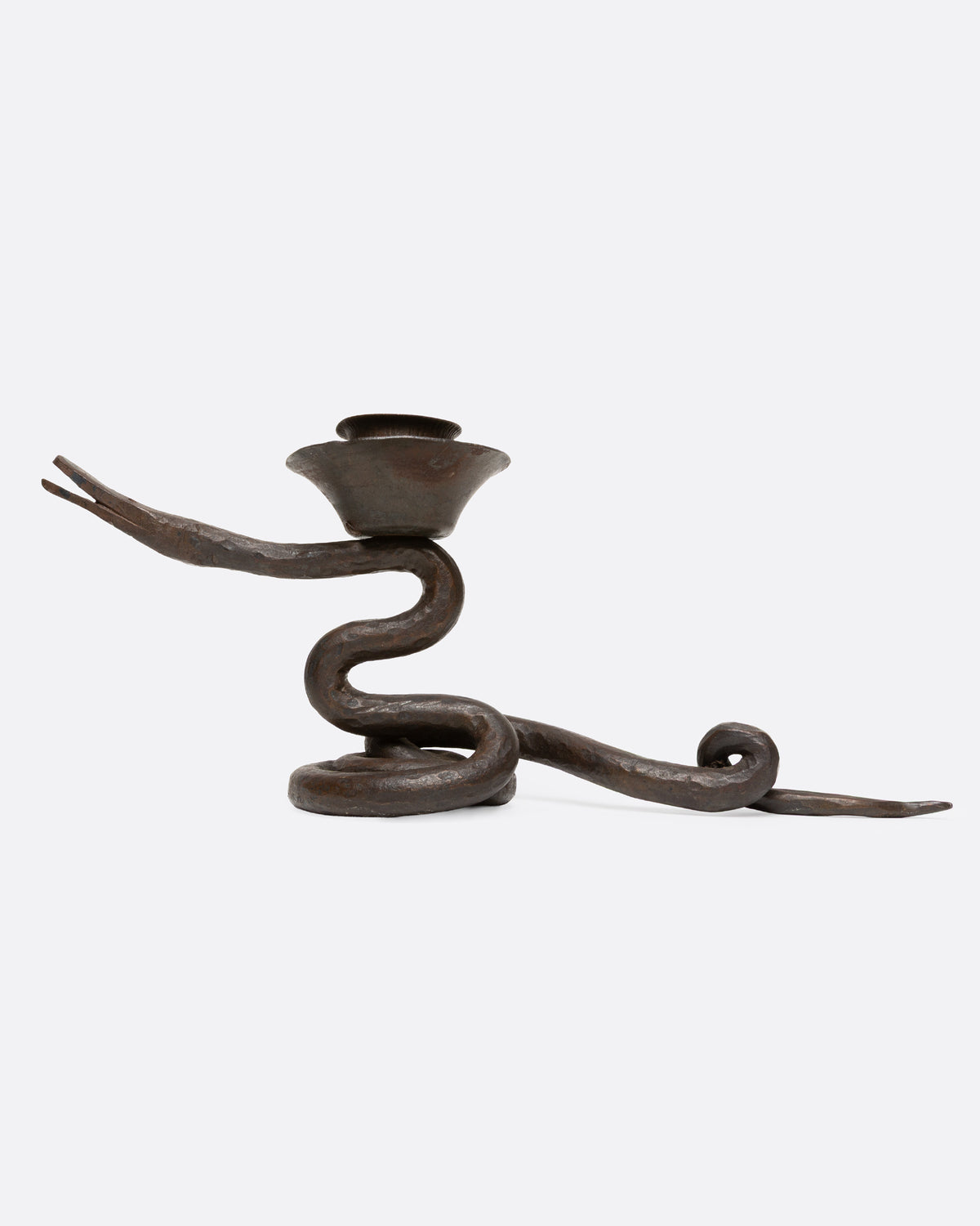 An iron coiling iron snake candle holder, shown from the side.