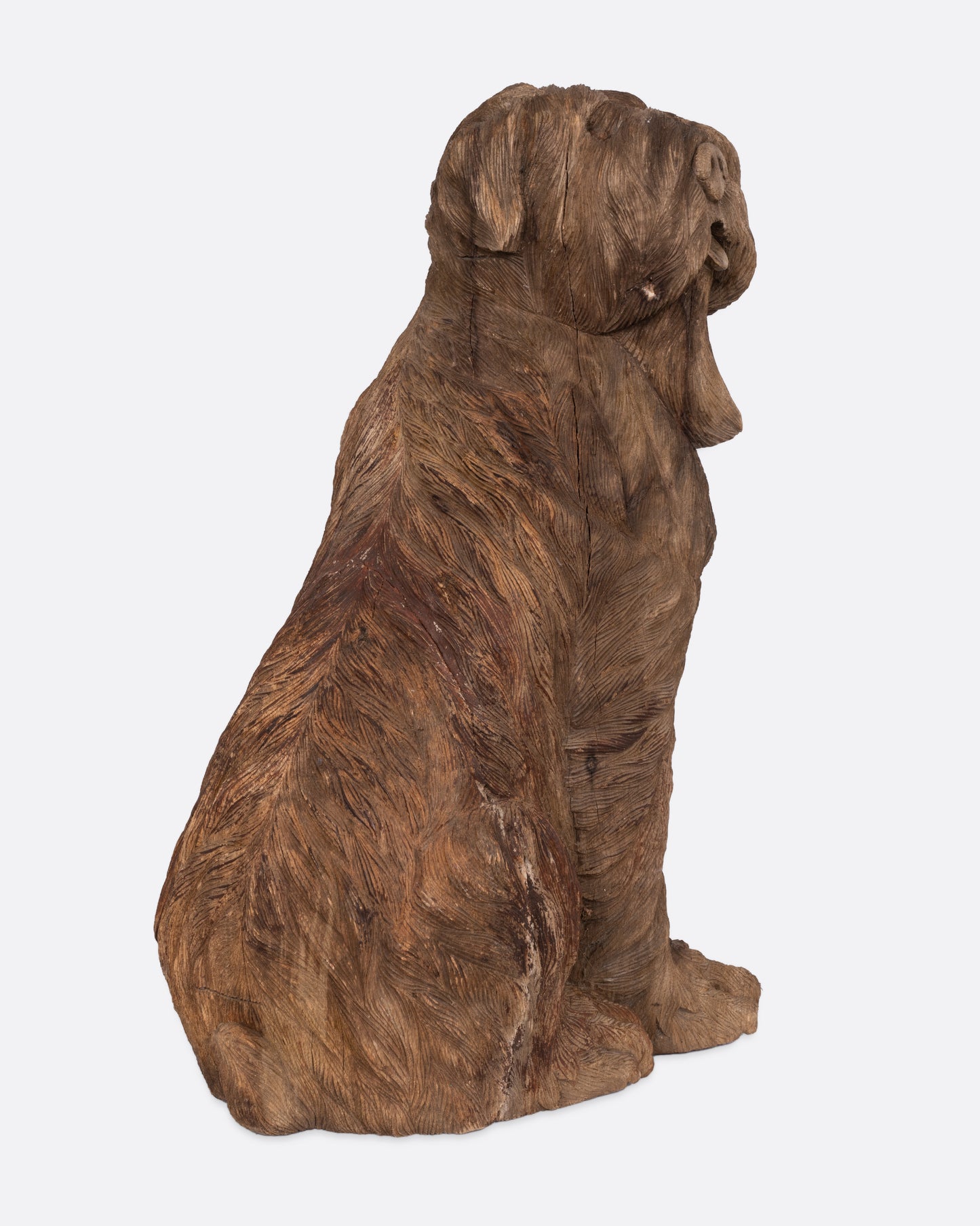 A wooden dog takaan sculpture shown from the side.