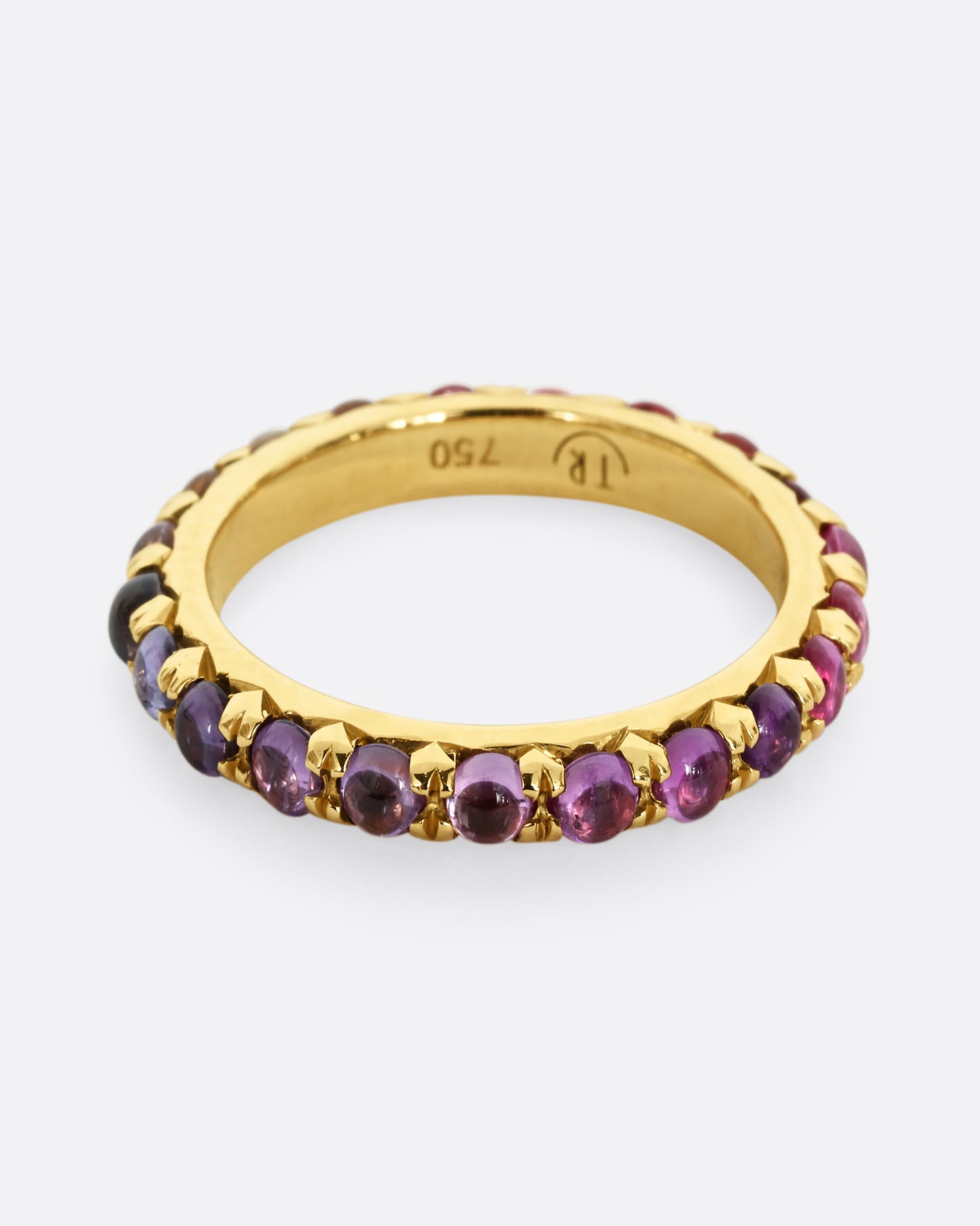 A yellow gold eternity band with pink and purple sapphire cabochons.