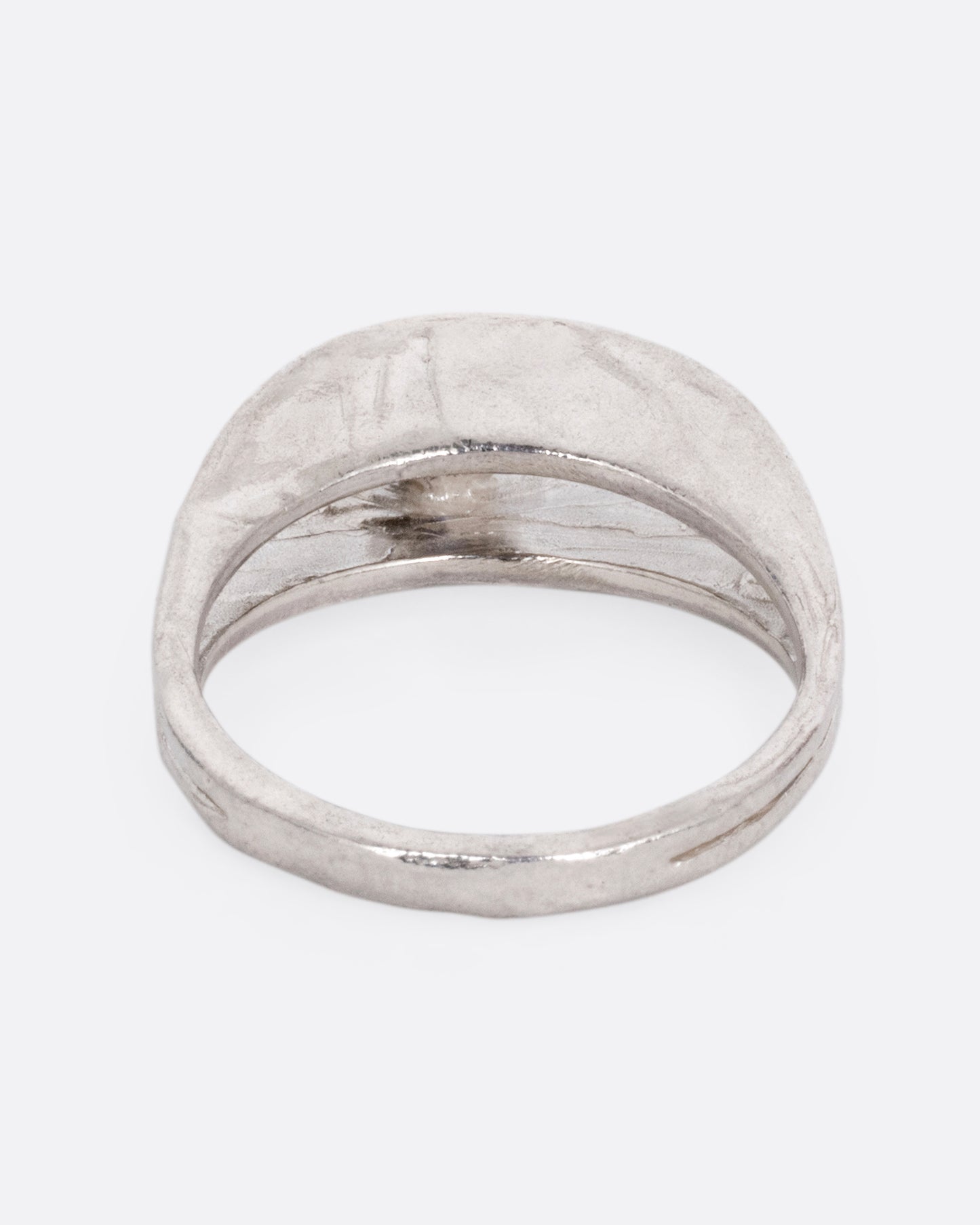 A silver ring with a split shank and a center iolite, shown from the back.