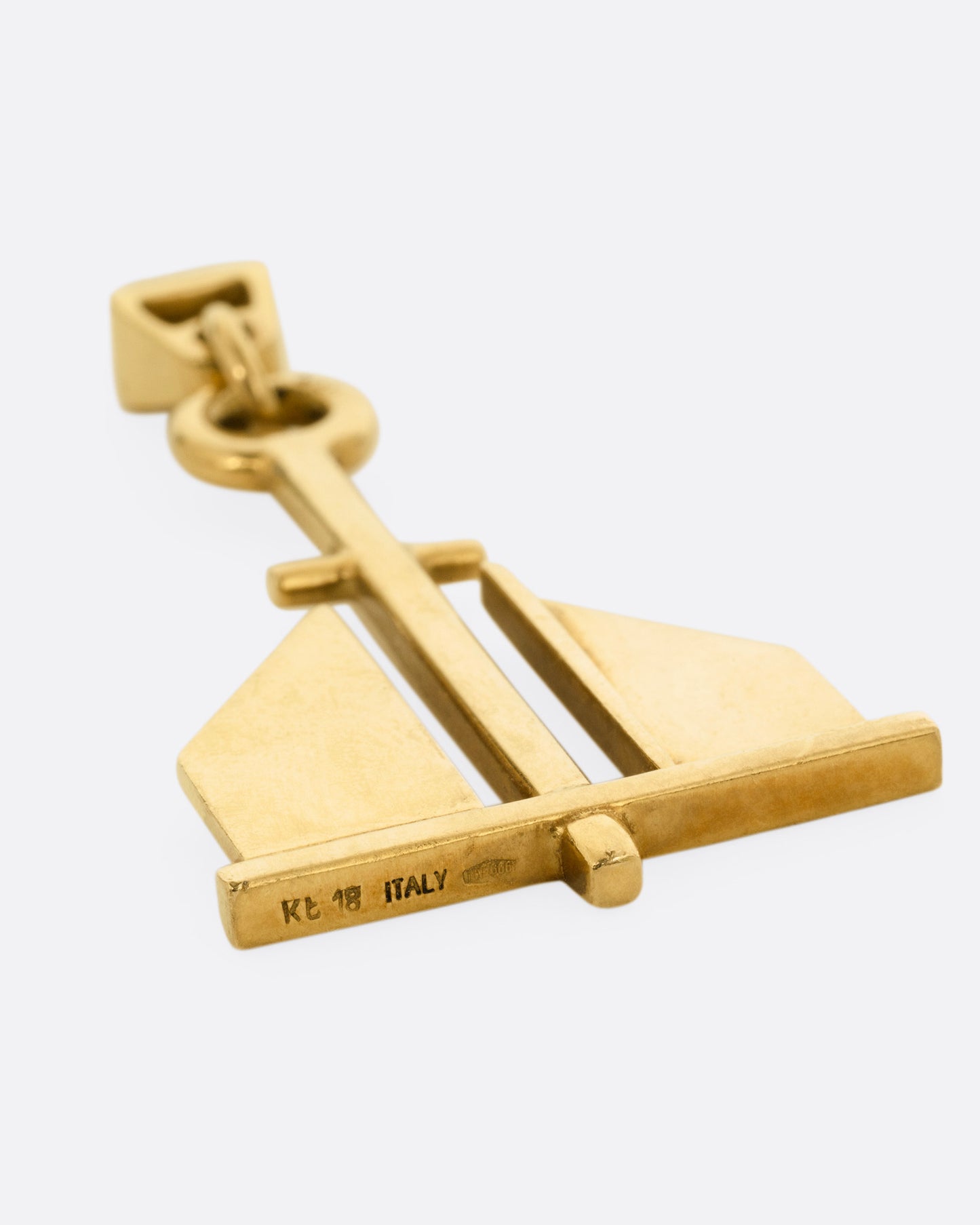 A yellow gold anchor pendant, shown from the back.